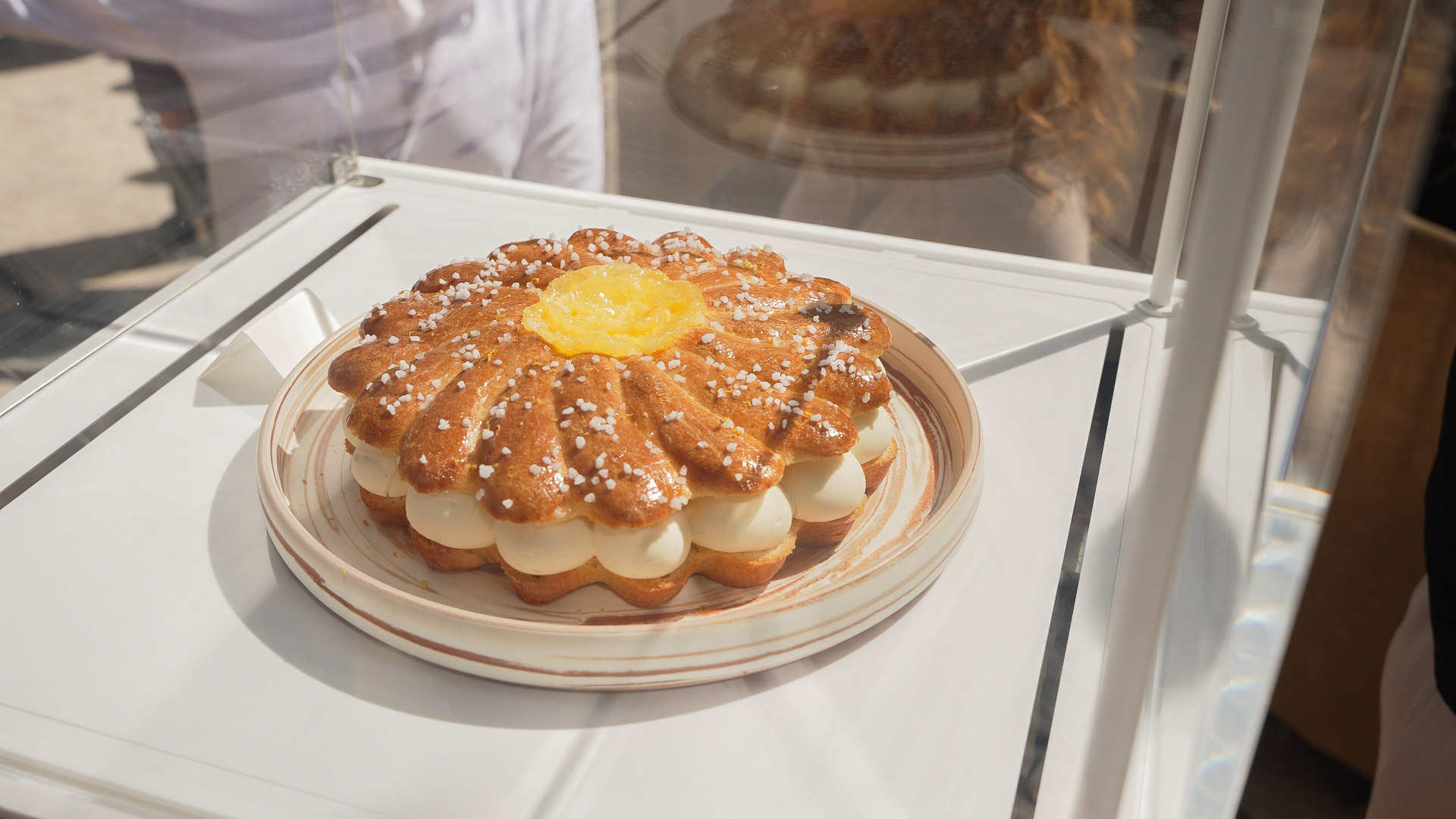 Tarte tropézienne briochée garnie de crème et d'un insert citron, présentée dans une vitrine OCF Matfer Bourgeat
